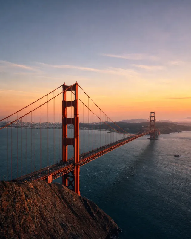 San Francisco's Golden Gate Bridge in warm sunset light over the bay.